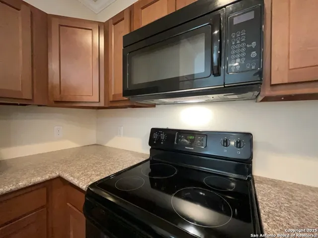 a kitchen with a stove microwave and cabinets
