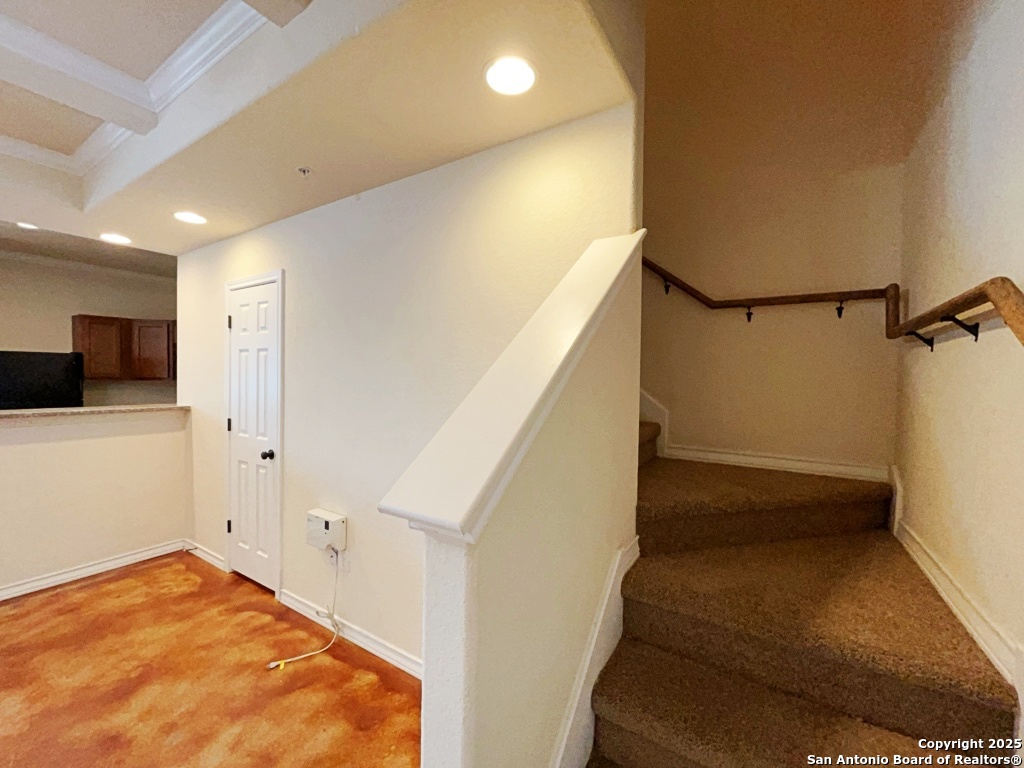 16821 Showdown Path, Unit 3 Selma, TX 78154 - Photo 16 of 37 a view of a hallway to an empty room with wooden floor and stairs
