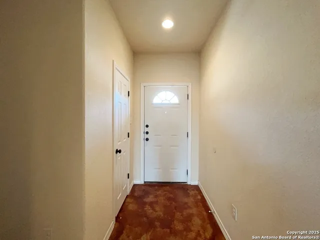 a view of a hallway with a bathroom