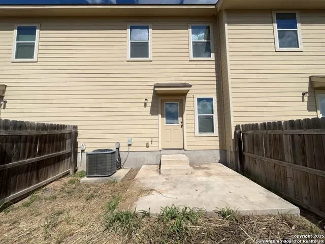 a backyard of a house with wooden floor and large window