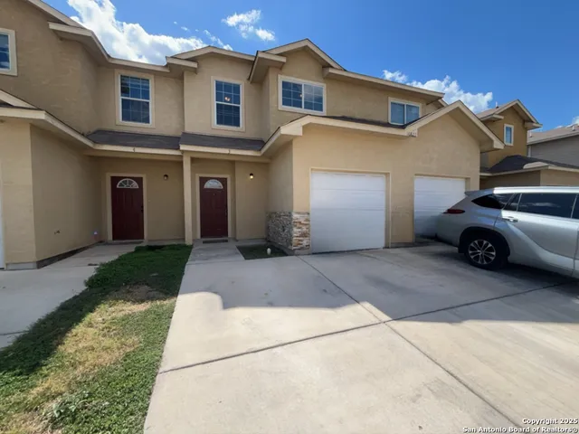 a view of a car parked front of a house