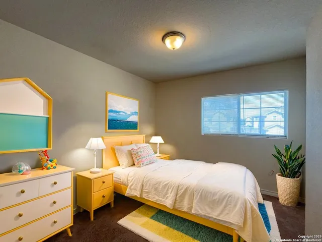 a bedroom with a bed and a potted plant