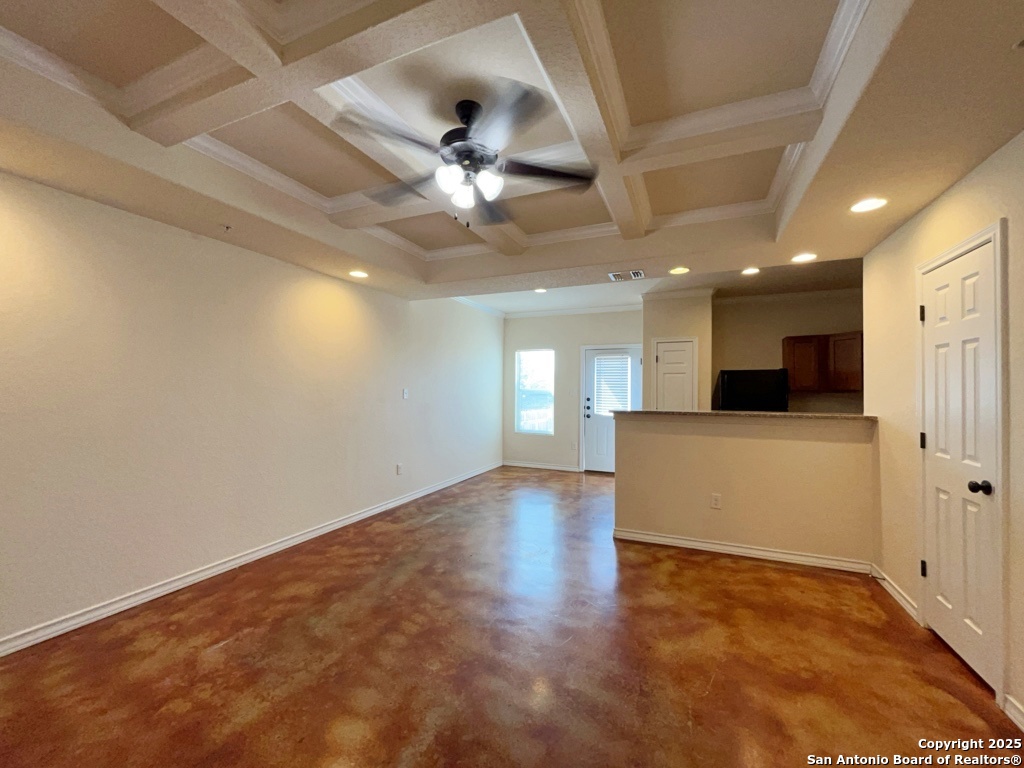 16821 Showdown Path, Unit 3 Selma, TX 78154 - Photo 9 of 37 an empty room with wooden floor and windows