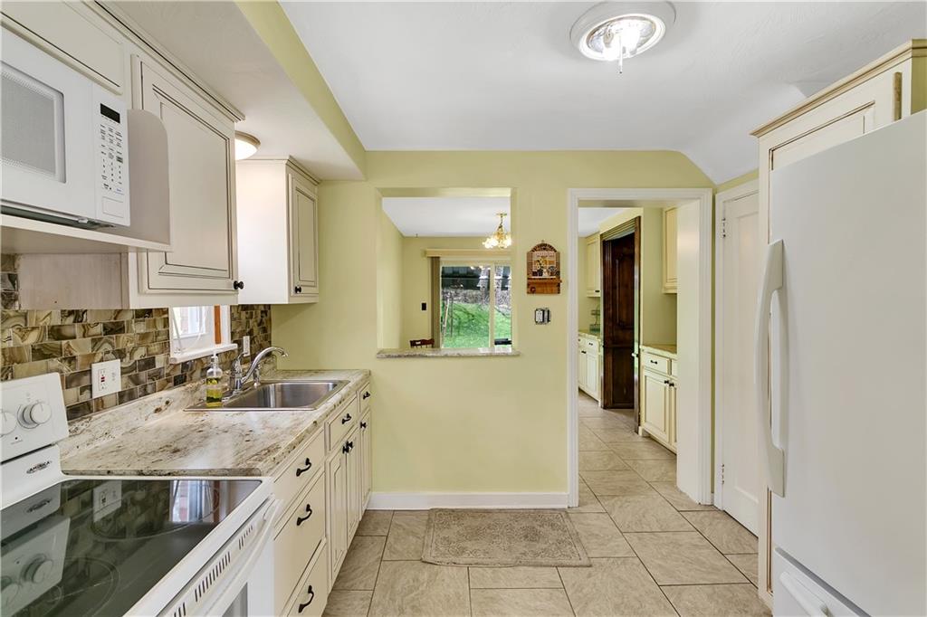 767 Beulah Road Pittsburgh, PA 15235 - Photo 12 of 25 a kitchen with stainless steel appliances granite countertop a refrigerator and a sink