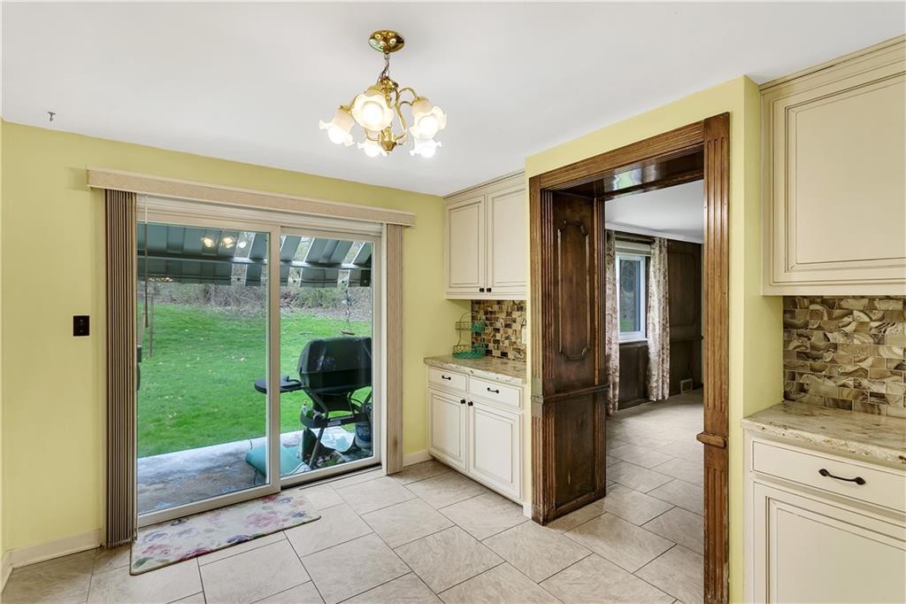 767 Beulah Road Pittsburgh, PA 15235 - Photo 15 of 25 a view of a hallway with dining area and chandelier