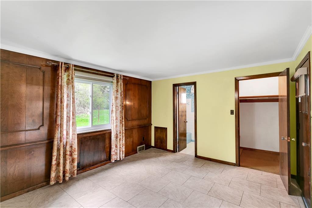 767 Beulah Road Pittsburgh, PA 15235 - Photo 17 of 25 a view of an empty room with a fireplace and a window