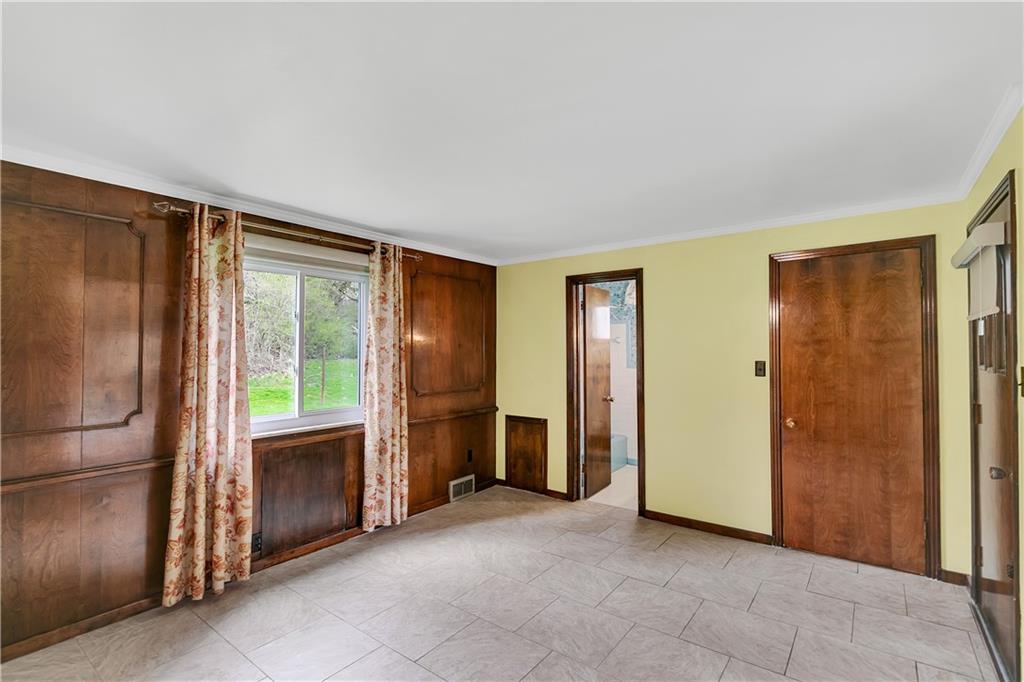 767 Beulah Road Pittsburgh, PA 15235 - Photo 18 of 25 an empty room with windows closet and chandelier