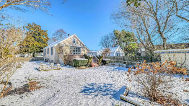 a view of a house with a yard and tree s