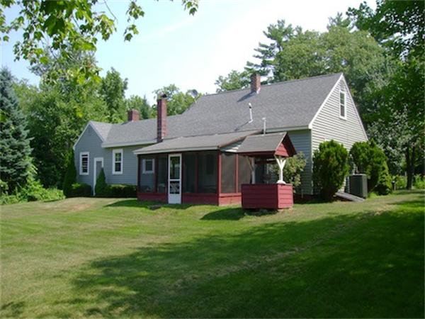 274 Wallace Hill Road Townsend, MA 01469 - Photo 2 of 27 a front view of a house with a garden and trees