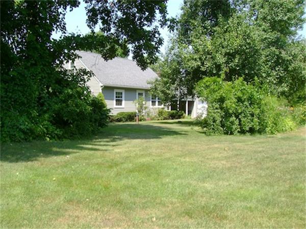 274 Wallace Hill Road Townsend, MA 01469 - Photo 6 of 27 a front view of a house with a garden