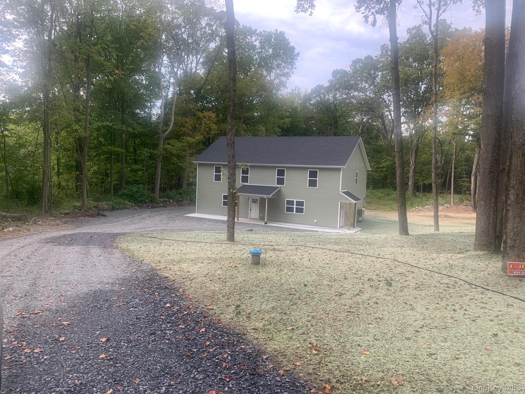 11 East Alexandra Matthews Wallkill, NY 12589 - Photo 1 of 9 View of front facade featuring asphalt driveway and covered porch
