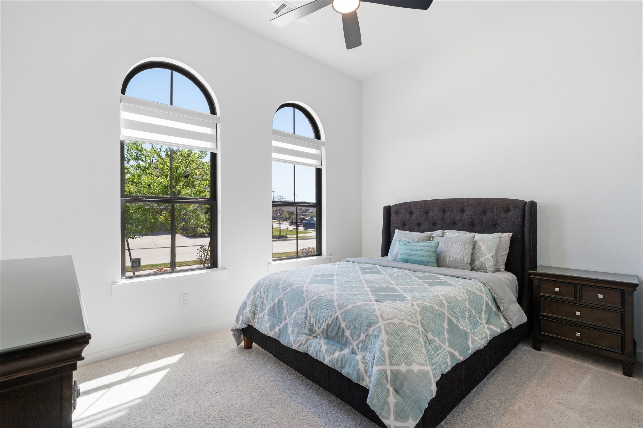 416 Bartlett Street Webster, TX 77598 - Photo 34 of 49 Third bedroom with arched windows, carpet, and abundant natural light