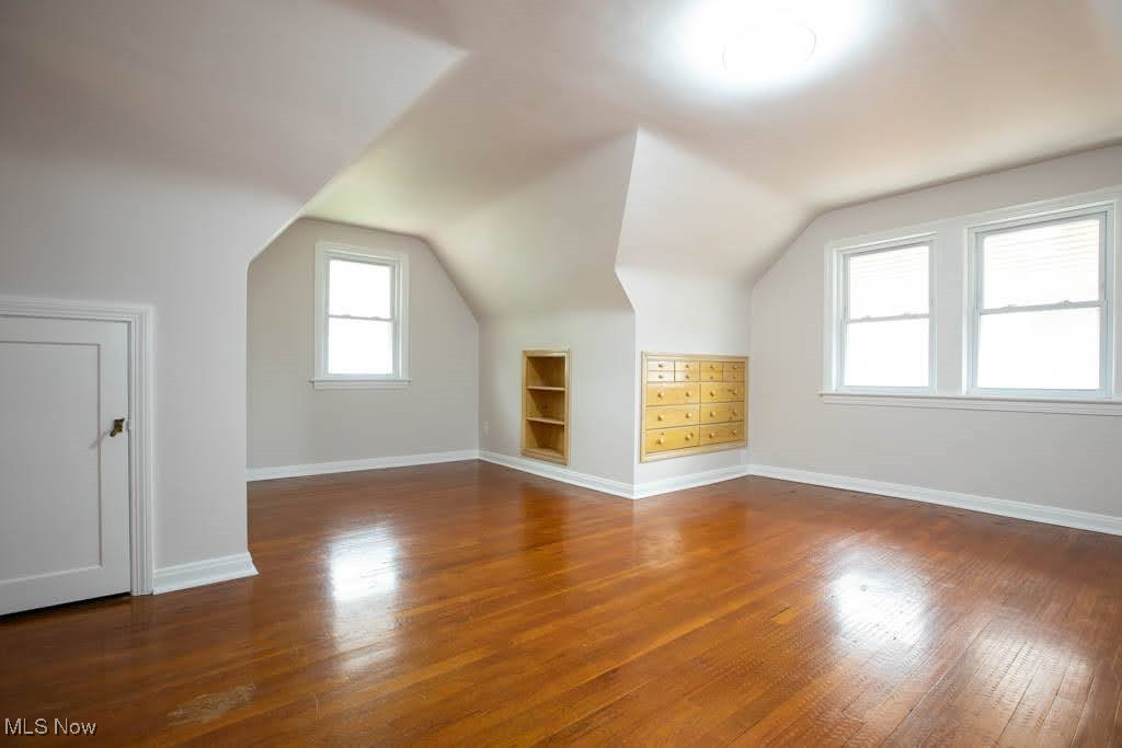 12822 Grannis Road Cleveland, OH 44125 - Photo 16 of 44 Additional living space featuring wood-type flooring, vaulted ceiling, and built in features