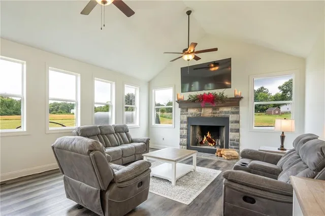 a living room with furniture a window and a fireplace