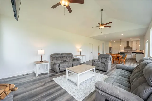 a living room with furniture and a ceiling fan