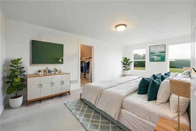 a bedroom with a bed and a flat screen television