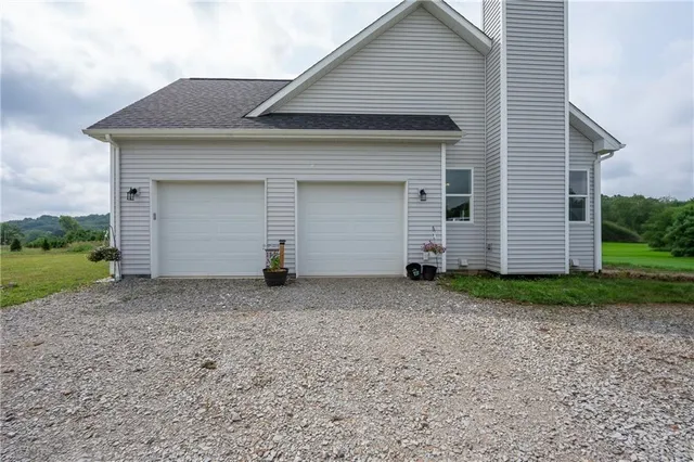 an aerial view of a house with yard