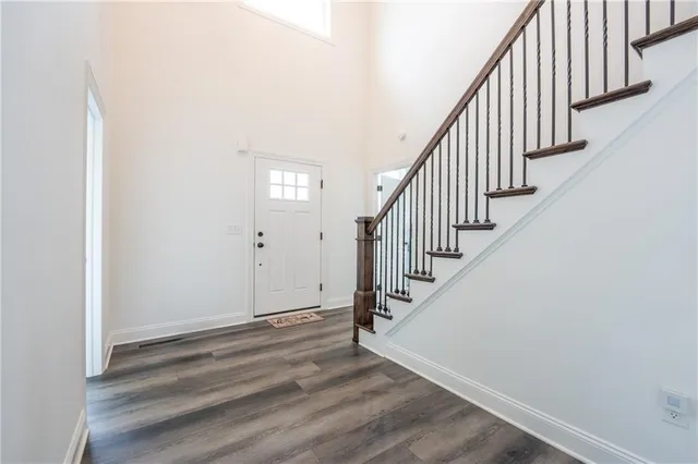 a view of entryway and hall with wooden floor