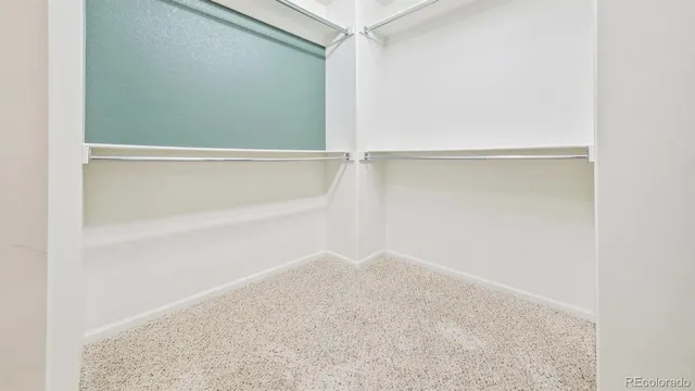 a view of a room with a window and a ceiling fan