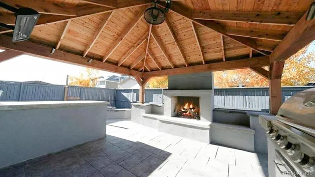 a view of a patio with a table and chairs under an umbrella