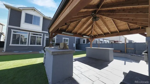 a view of a backyard with couches plants and kitchen