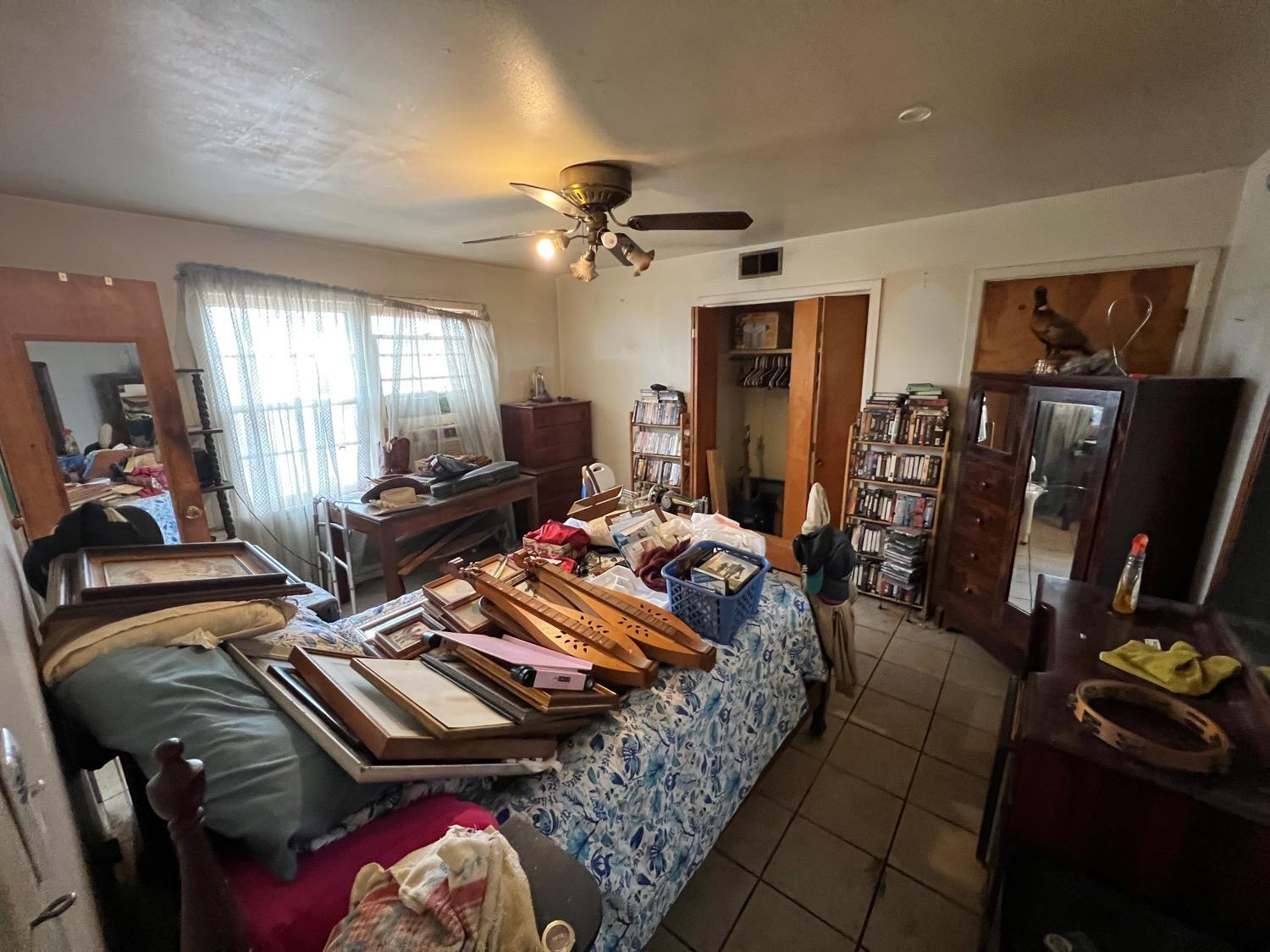 4812 46th Street Lubbock, TX 79414 - Photo 3 of 9 a bedroom with furniture and a flat screen tv
