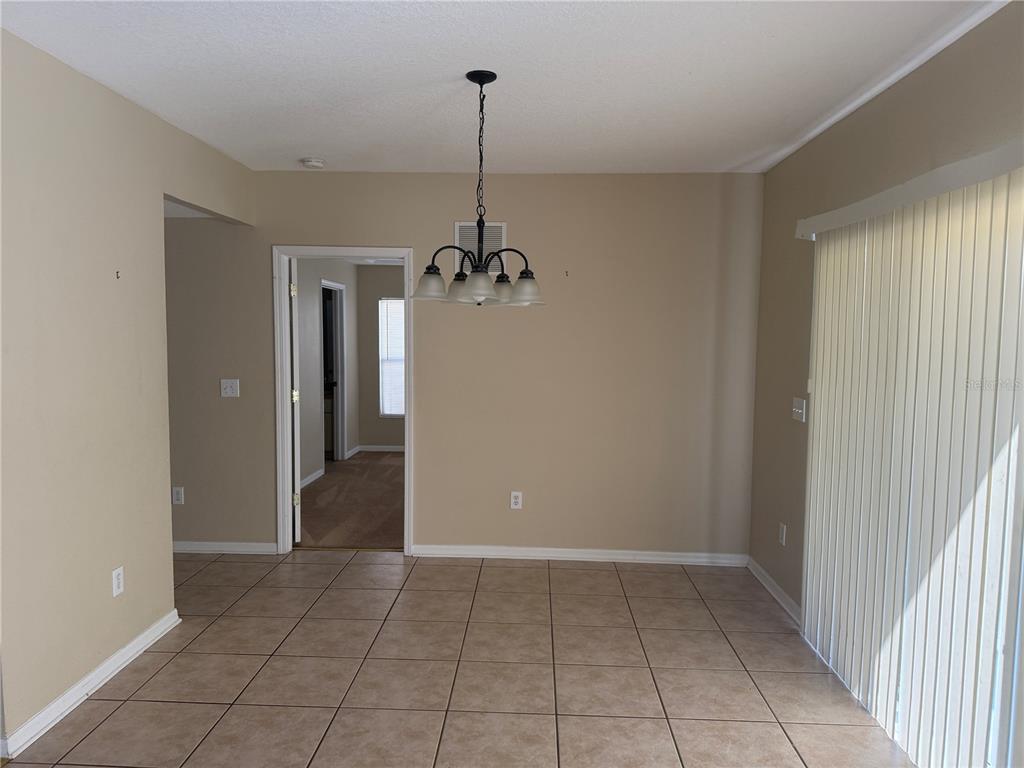 6509 Bridgecrest Drive Lithia, FL 33547 - Photo 6 of 15 a view of a room with a chandelier fan and windows