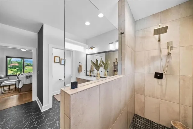 a view of a bathroom with tub and shower