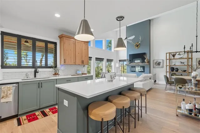 a kitchen with a table chairs sink and cabinets