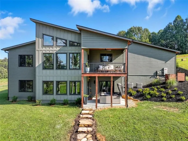 a view of an house with backyard porch and furniture