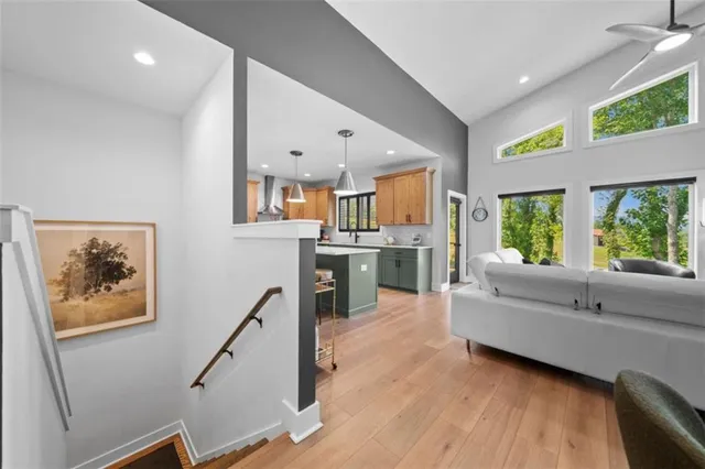 a living room with stainless steel appliances kitchen island granite countertop furniture and a window