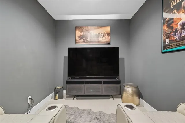 a living room with a flat screen tv and a toilet