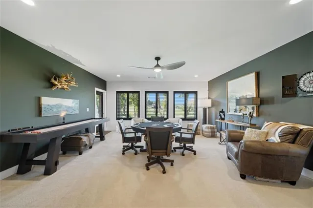 a living room with furniture and large windows