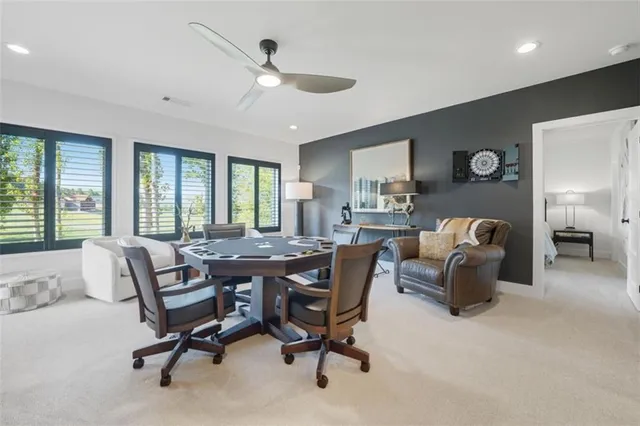 a view of a livingroom with workspace and a window
