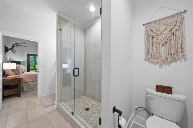 a bathroom with a toilet and a shower