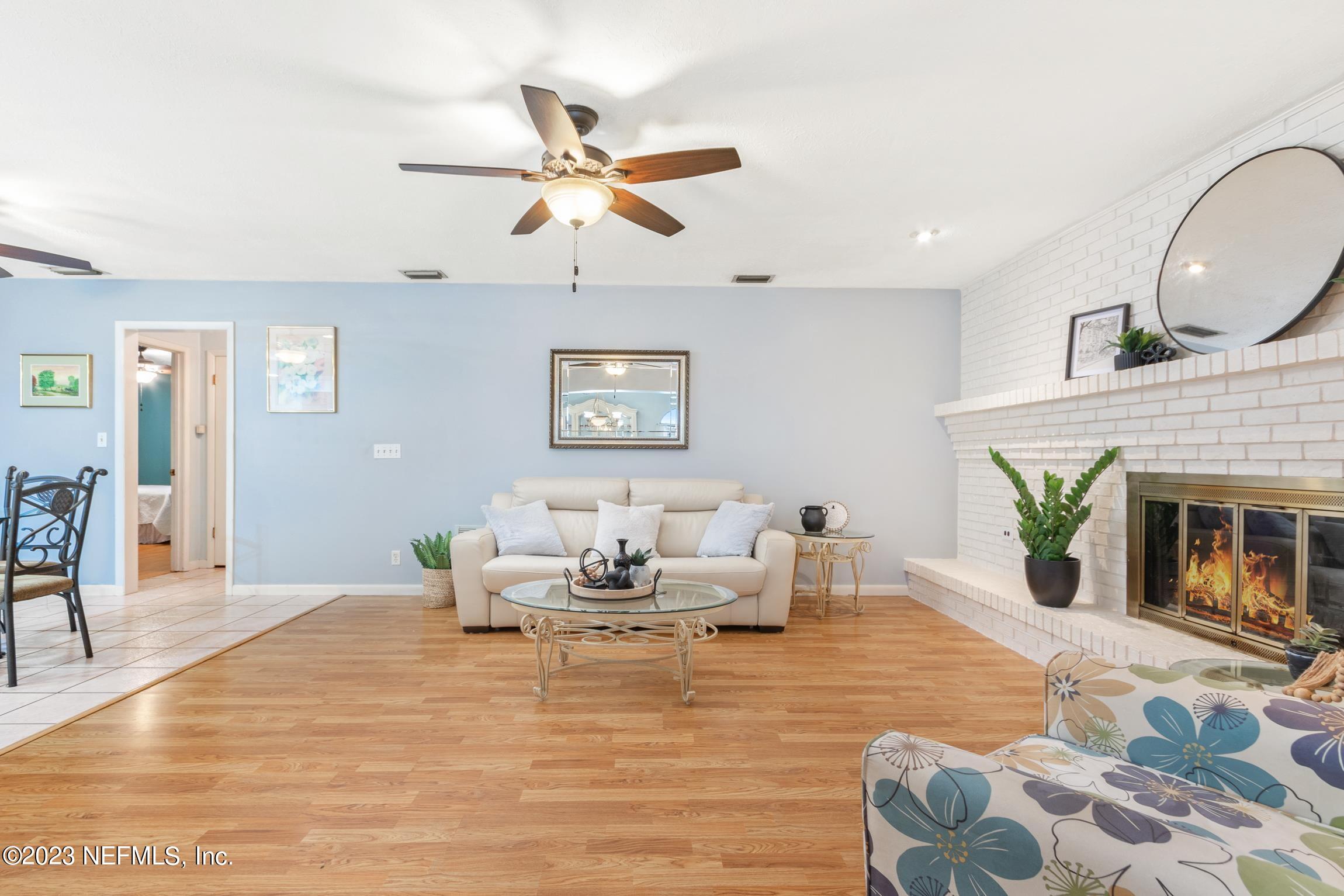 1131 Prince Road St. Augustine, FL 32086 - Photo 13 of 29 a living room with furniture wooden floor and a fireplace