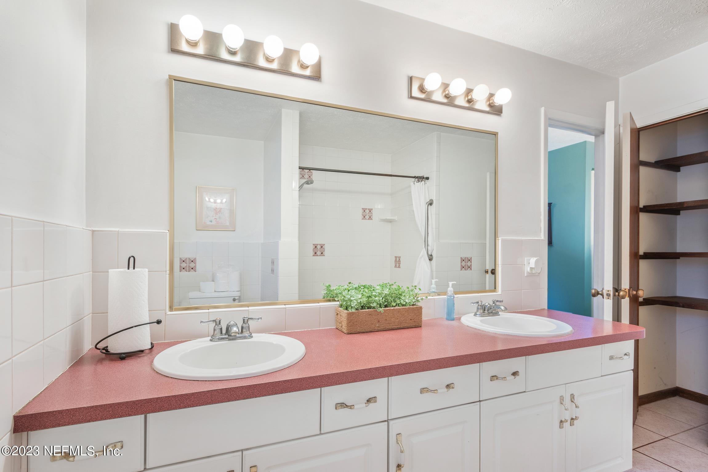 1131 Prince Road St. Augustine, FL 32086 - Photo 16 of 29 a bathroom with a sink double vanity and a mirror