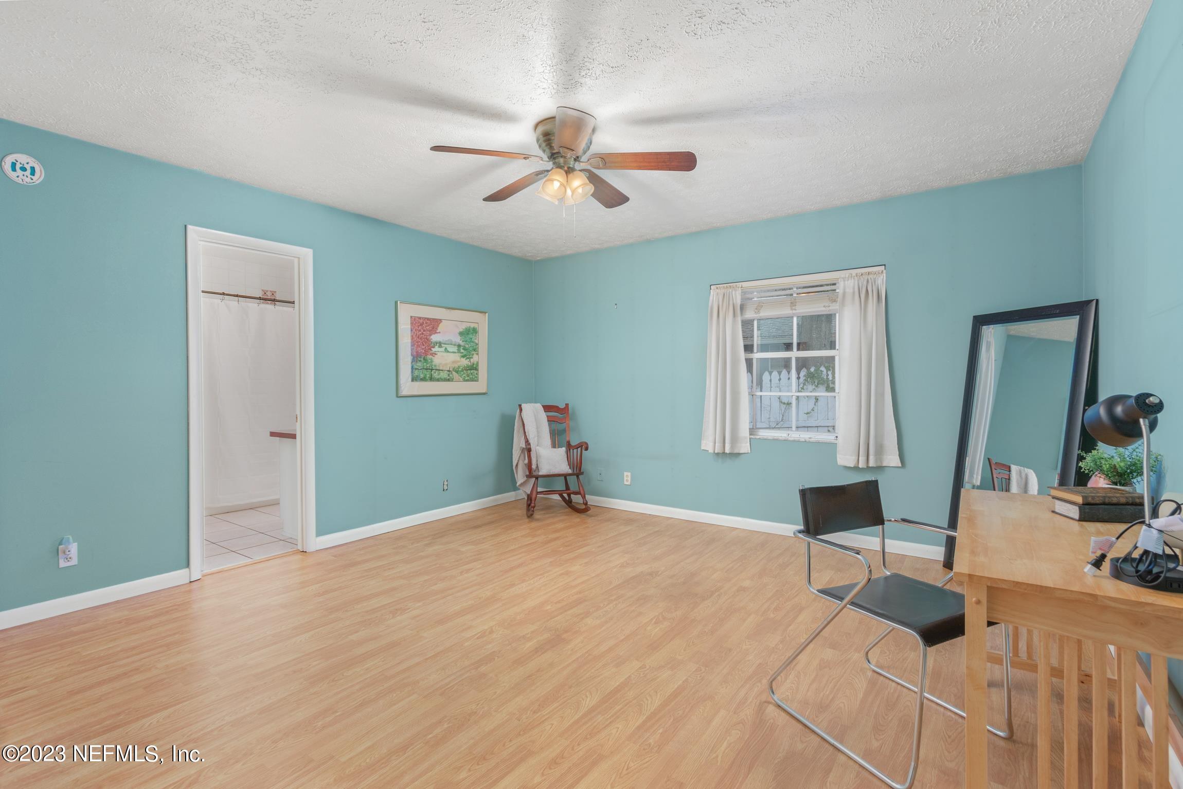 1131 Prince Road St. Augustine, FL 32086 - Photo 18 of 29 a bedroom with a large bed and a chandelier