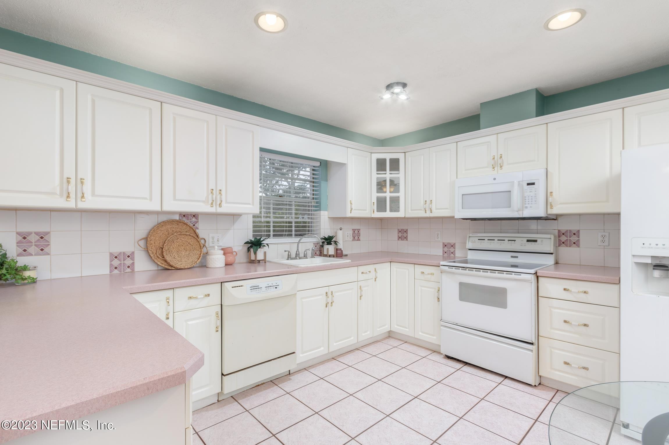 1131 Prince Road St. Augustine, FL 32086 - Photo 3 of 29 a kitchen with granite countertop white cabinets and white appliances