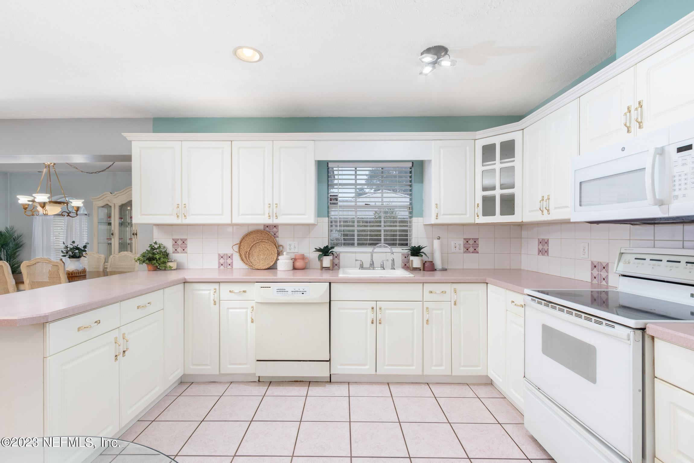 1131 Prince Road St. Augustine, FL 32086 - Photo 5 of 29 a kitchen with white cabinets appliances and a sink