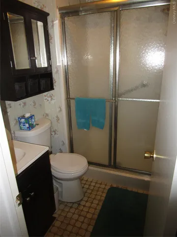 a bathroom with a sink a toilet and mirror