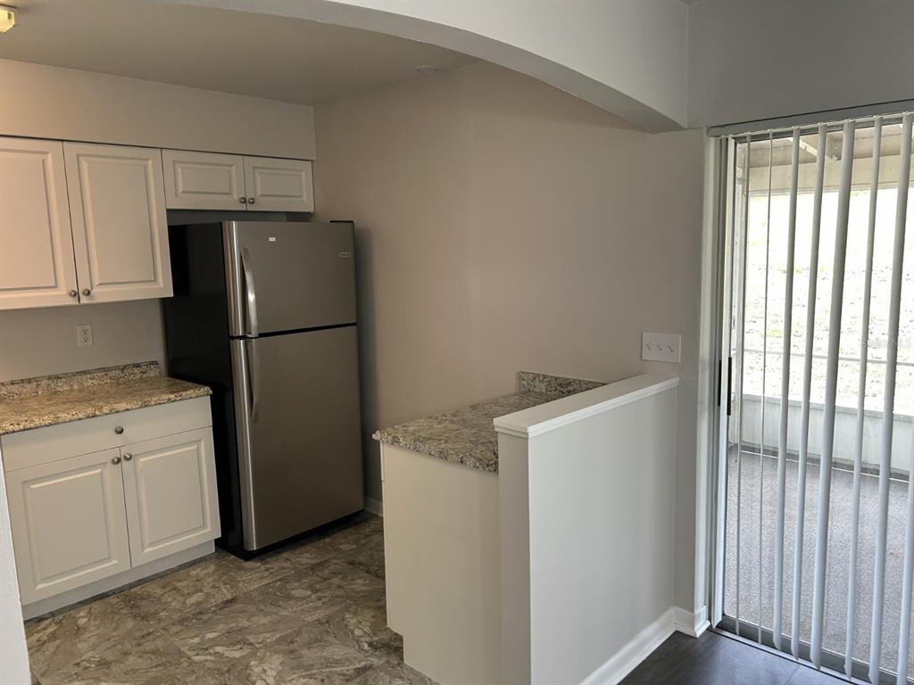 1241 Pilgrim Road Spring Hill, FL 34606 - Photo 11 of 28 a utility room with cabinets washer and dryer