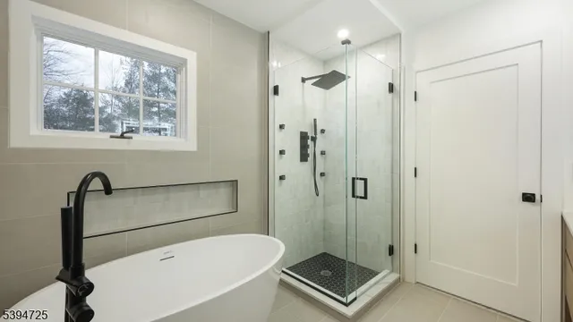 a bathroom with a shower bathtub and window