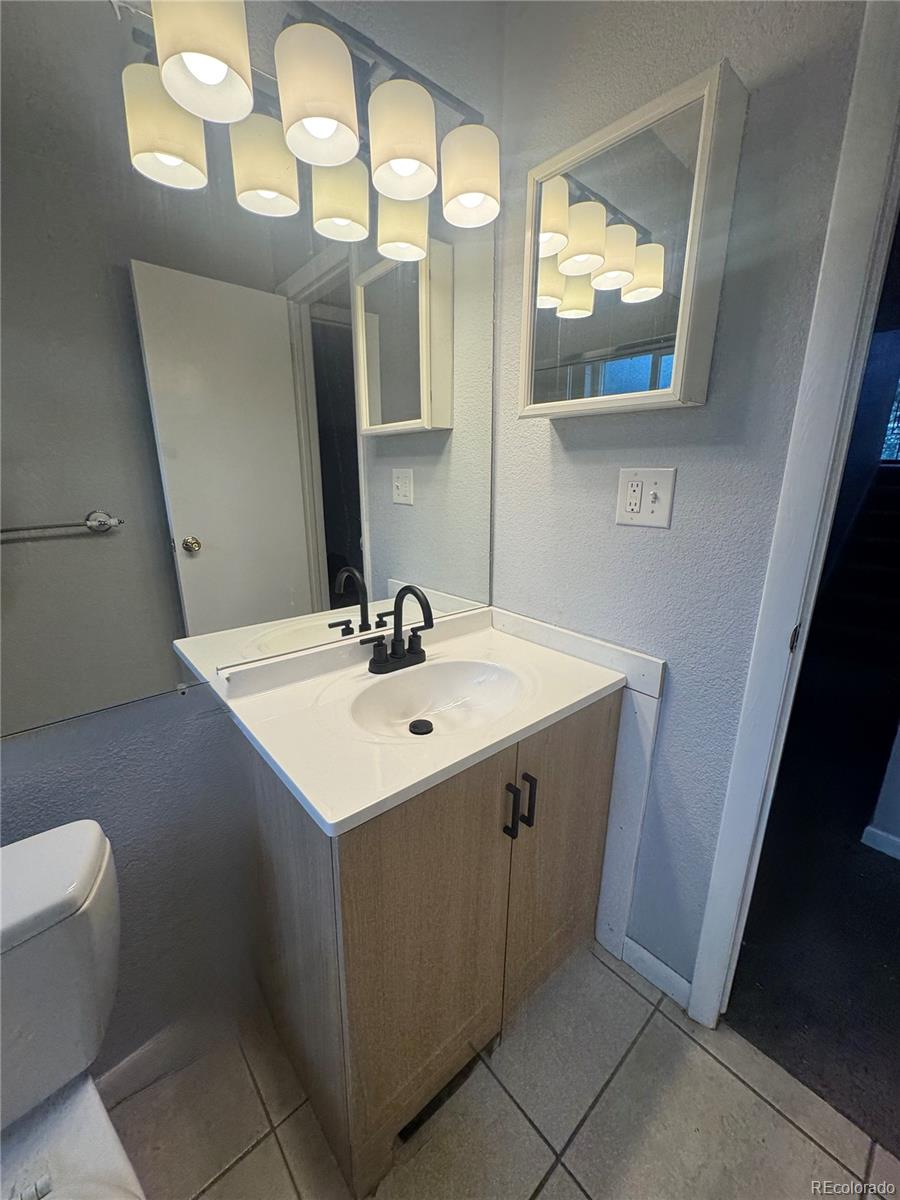 1273 Moore Street, Unit 1273 Denver, CO 80215 - Photo 7 of 13 a bathroom with a sink and a mirror