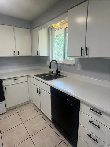 a kitchen with a sink cabinets and window