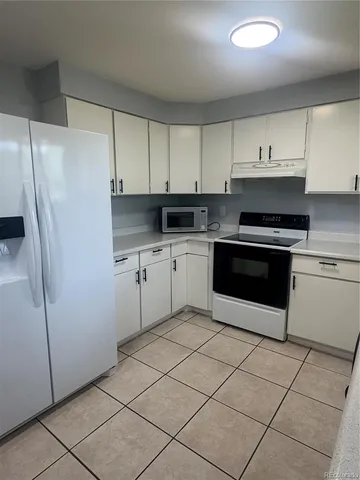 a kitchen with stainless steel appliances a stove a sink and a refrigerator