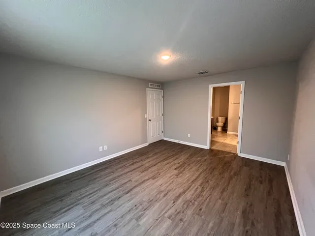 a bathroom with a granite countertop sink a toilet and a mirror