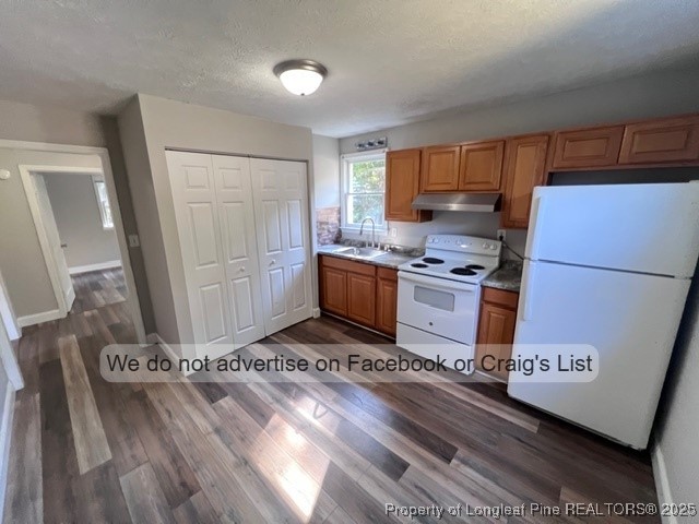 4252 Deadwyler Drive Fayetteville, NC 28311 - Photo 3 of 7 a kitchen with a refrigerator a stove top oven a sink and a counter space
