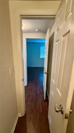 a view of hallway with wooden floor and stairs