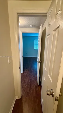 a view of hallway with wooden floor and stairs